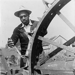 Sam Crawford oiling tractor on his Maryland farm. (Library of Congress, 1943)